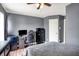 Comfortable bedroom with window, carpet flooring, ceiling fan, and desk workspace at 6809 Amber Springs Way, Indianapolis, IN 46237