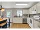 Well-lit kitchen featuring white cabinets, stainless steel appliances and tile backsplash at 6809 Amber Springs Way, Indianapolis, IN 46237