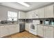 Clean kitchen featuring stainless appliances, light countertops, white cabinets and a window over the sink at 6809 Amber Springs Way, Indianapolis, IN 46237