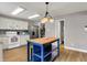 Bright kitchen with white cabinets, stainless steel appliances, tile backsplash and an island at 6809 Amber Springs Way, Indianapolis, IN 46237