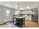 Modern kitchen with stainless steel appliances, ample cabinet space, and a functional island at 6809 Amber Springs Way, Indianapolis, IN 46237