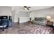 Spacious living room with laminate flooring, ceiling fan and comfortable seating, perfect for relaxing and entertaining at 6809 Amber Springs Way, Indianapolis, IN 46237