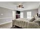 Comfortable main bedroom features carpet, light gray walls, a ceiling fan and windows at 6809 Amber Springs Way, Indianapolis, IN 46237