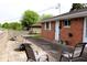 Charming back patio with outdoor seating, table, fire pit, and a brick home exterior at 706 Bobs Ct, Beech Grove, IN 46107