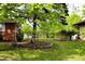 Well-maintained backyard with lush greenery, mature trees, and a fenced perimeter at 706 Bobs Ct, Beech Grove, IN 46107