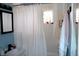 Bathroom featuring a shower-tub combo, patterned window, and a single vanity with plenty of storage at 706 Bobs Ct, Beech Grove, IN 46107