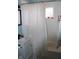 Bathroom featuring a shower-tub combo, patterned window, and a single vanity with plenty of storage at 706 Bobs Ct, Beech Grove, IN 46107