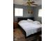 Bedroom featuring hardwood floors, two windows offering great natural light, ceiling fan, and neutral paint at 706 Bobs Ct, Beech Grove, IN 46107
