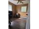 Bright bedroom featuring wood floors, a ceiling fan, and natural light from the windows at 706 Bobs Ct, Beech Grove, IN 46107