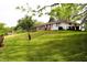 Beautiful exterior view of a home with a well-maintained lawn and mature trees at 706 Bobs Ct, Beech Grove, IN 46107