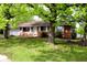 Brick ranch-style home with a well-maintained lawn and mature trees at 706 Bobs Ct, Beech Grove, IN 46107