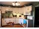 Functional kitchen with white cabinets, laminate countertops, and modern appliances at 706 Bobs Ct, Beech Grove, IN 46107