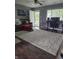 Spacious living room featuring a cozy brown sofa and a large, plush white rug at 706 Bobs Ct, Beech Grove, IN 46107