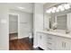 Well-lit bathroom featuring double vanity with marble countertop and walk-in closet at 714 Thornburg Pkwy, Brownsburg, IN 46112