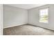 Bedroom featuring gray walls, carpet floors, and a window to let in natural light at 714 Thornburg Pkwy, Brownsburg, IN 46112