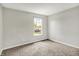 This carpeted bedroom offers a bright window providing natural light at 714 Thornburg Pkwy, Brownsburg, IN 46112