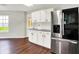 Eat-in kitchen featuring wood floors, stainless appliances, and white cabinets at 714 Thornburg Pkwy, Brownsburg, IN 46112