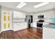 Bright kitchen with wood floors, stainless steel refrigerator and microwave, and white cabinets at 714 Thornburg Pkwy, Brownsburg, IN 46112