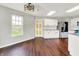 Modern kitchen featuring white cabinets, granite countertops, and stainless-steel appliances overlooking the backyard at 714 Thornburg Pkwy, Brownsburg, IN 46112