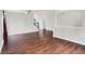 Open-concept living room featuring sleek hardwood floors and easy access to the staircase at 714 Thornburg Pkwy, Brownsburg, IN 46112