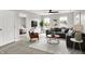 The modern living room has stylish furniture, a ceiling fan, and great natural light from the double windows at 714 Thornburg Pkwy, Brownsburg, IN 46112