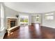 Open-concept living room with fireplace and view of dining room and backyard at 714 Thornburg Pkwy, Brownsburg, IN 46112