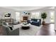 Bright living room with hardwood floors, stone fireplace, comfortable seating, and plenty of natural light at 714 Thornburg Pkwy, Brownsburg, IN 46112