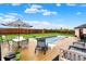 Backyard patio with in-ground pool, lounge chairs, and dining area under umbrella at 714 Thornburg Pkwy, Brownsburg, IN 46112