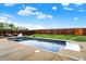 A look at a sparkling in-ground pool surrounded by concrete deck and a wood fence at 714 Thornburg Pkwy, Brownsburg, IN 46112