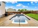 A look at an in-ground pool and patio area with wood fence and a nearby home at 714 Thornburg Pkwy, Brownsburg, IN 46112