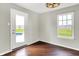 Bright room features wood floors, large window, and patio door with a view of the backyard pool at 714 Thornburg Pkwy, Brownsburg, IN 46112