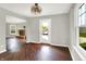 Room with a fireplace, wood floors, natural light, ceiling fan, and access to backyard at 714 Thornburg Pkwy, Brownsburg, IN 46112