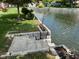 Beautiful backyard featuring lush greenery, a canal waterfront view, and mature trees at 7440 Sylvan Ridge Rd, Indianapolis, IN 46240