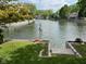 Picturesque backyard offering waterfront canal views, a grassy lawn, and manicured landscaping at 7440 Sylvan Ridge Rd, Indianapolis, IN 46240