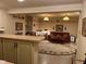 Spacious basement living area with paneled walls, wet bar, and comfortable seating at 7440 Sylvan Ridge Rd, Indianapolis, IN 46240