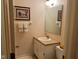 Functional bathroom with neutral tones, sink, toilet, and decorative mirror at 7440 Sylvan Ridge Rd, Indianapolis, IN 46240