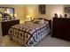 Comfortable bedroom showcasing a quilt bedspread, wood furnishings, and warm lighting at 7440 Sylvan Ridge Rd, Indianapolis, IN 46240