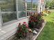 Well maintained home exterior with tidy landscaping featuring red roses at 7440 Sylvan Ridge Rd, Indianapolis, IN 46240