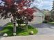 Well-maintained home featuring a two-car garage, mature landscaping and a beautiful red maple tree at 7440 Sylvan Ridge Rd, Indianapolis, IN 46240