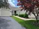 Charming home featuring a well-manicured lawn, mature trees, and a two-car garage at 7440 Sylvan Ridge Rd, Indianapolis, IN 46240