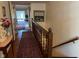 Hallway with hardwood floors and staircase leading to upper level, adorned with decorative accents at 7440 Sylvan Ridge Rd, Indianapolis, IN 46240