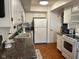Traditional-style kitchen featuring white cabinetry, granite counters, and hardwood flooring at 7440 Sylvan Ridge Rd, Indianapolis, IN 46240