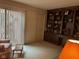 Cozy sitting area featuring a built-in bookcase, vertical blinds, and natural light at 7440 Sylvan Ridge Rd, Indianapolis, IN 46240