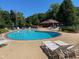 Community pool featuring plenty of lounge chairs for residents to relax by the blue water at 7440 Sylvan Ridge Rd, Indianapolis, IN 46240