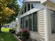 Charming sunroom featuring multiple windows and well maintained exterior landscaping at 7440 Sylvan Ridge Rd, Indianapolis, IN 46240