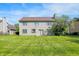 Well-maintained backyard featuring a spacious lawn, a mature tree, and siding exterior at 7587 Winding Way, Fishers, IN 46038