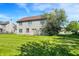 The property has a generous backyard with green grass and two story siding home at 7587 Winding Way, Fishers, IN 46038