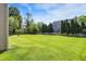 This backyard has green grass, wooden fences and mature trees for added privacy at 7587 Winding Way, Fishers, IN 46038