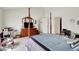 Bedroom with a four-poster bed, dresser, and closet door showcases a bright, spacious layout at 7587 Winding Way, Fishers, IN 46038