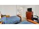 This bedroom has two twin beds with blue covers and a vintage wooden dresser at 7587 Winding Way, Fishers, IN 46038